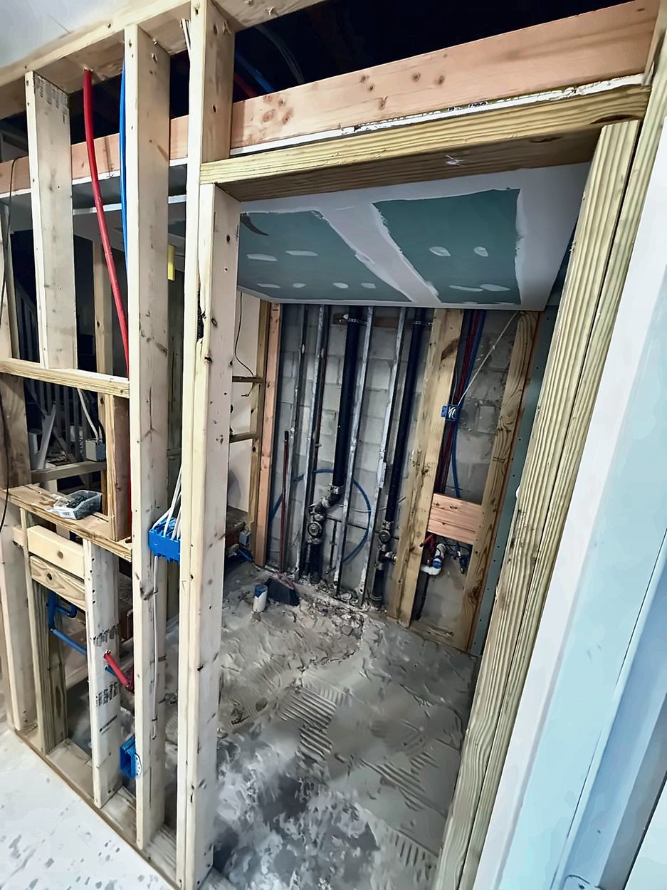 A new bathroom framed from scratch with the drain and vent stack run and the ceiling boarded